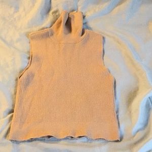 Sleeveless turtleneck crop top.
